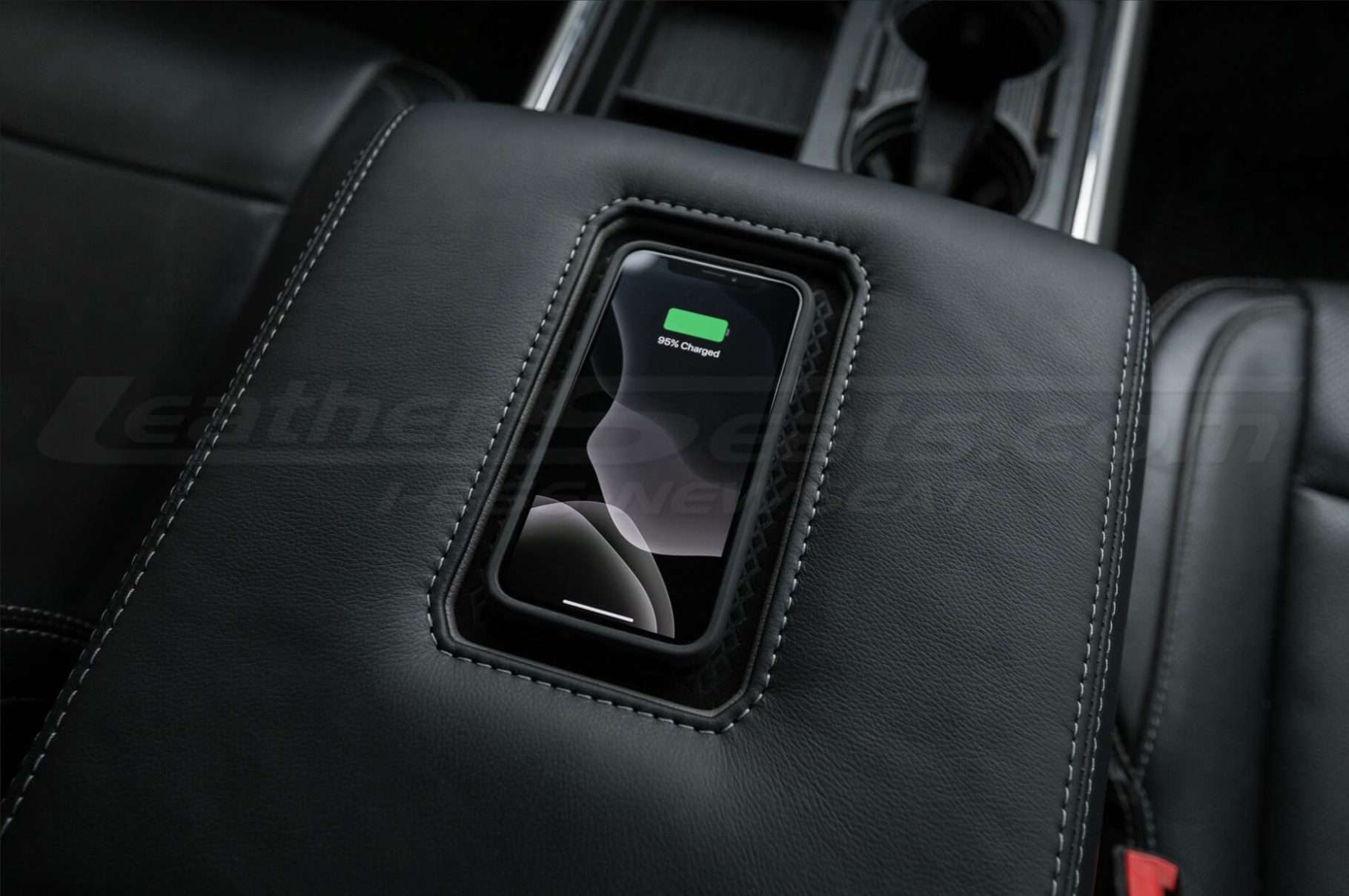 Phone being charged on Sanctum Wireless charging Venter console