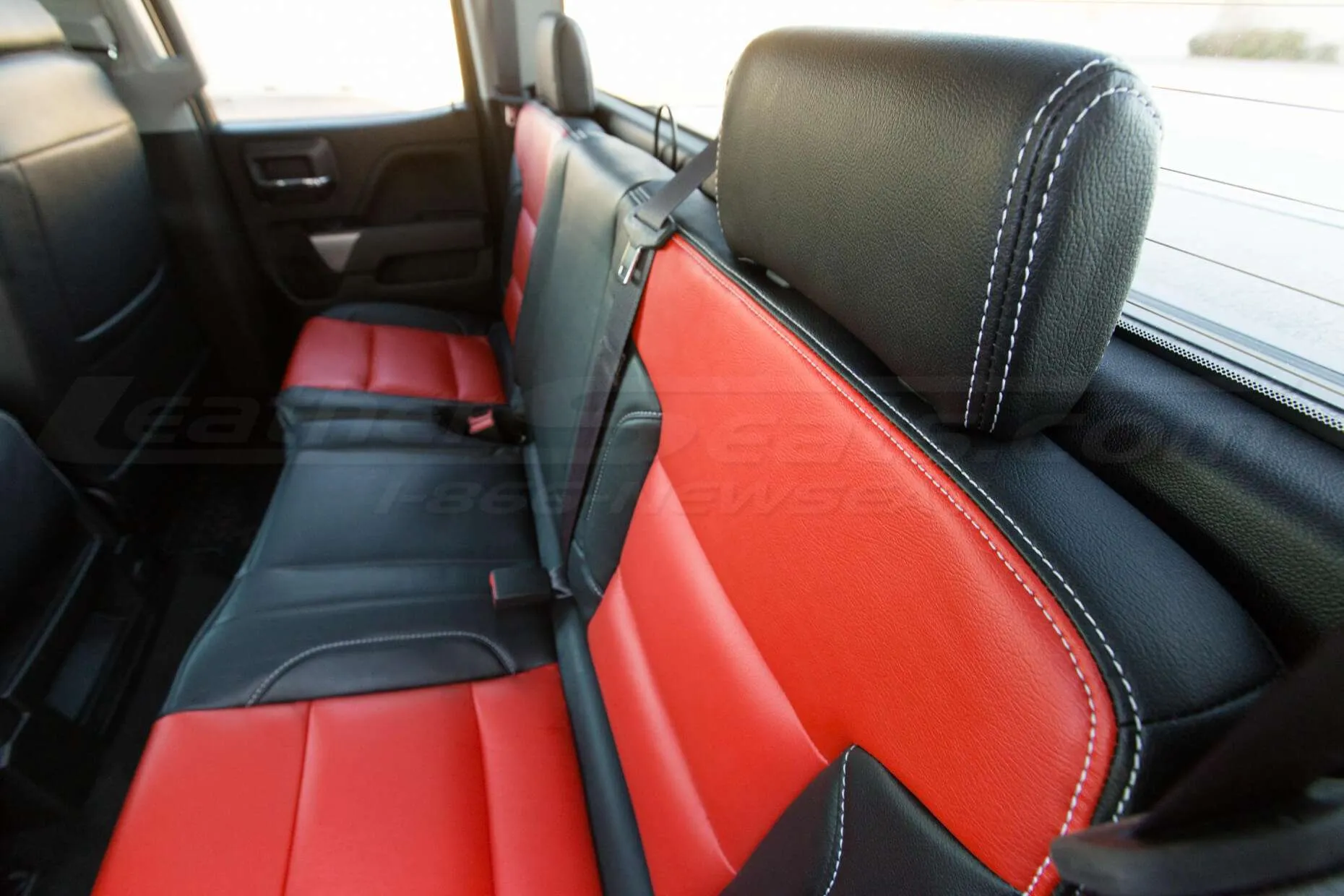 GMC Sierra leather upholstery kit - Black and Bright Red - Backseat headrest close-up