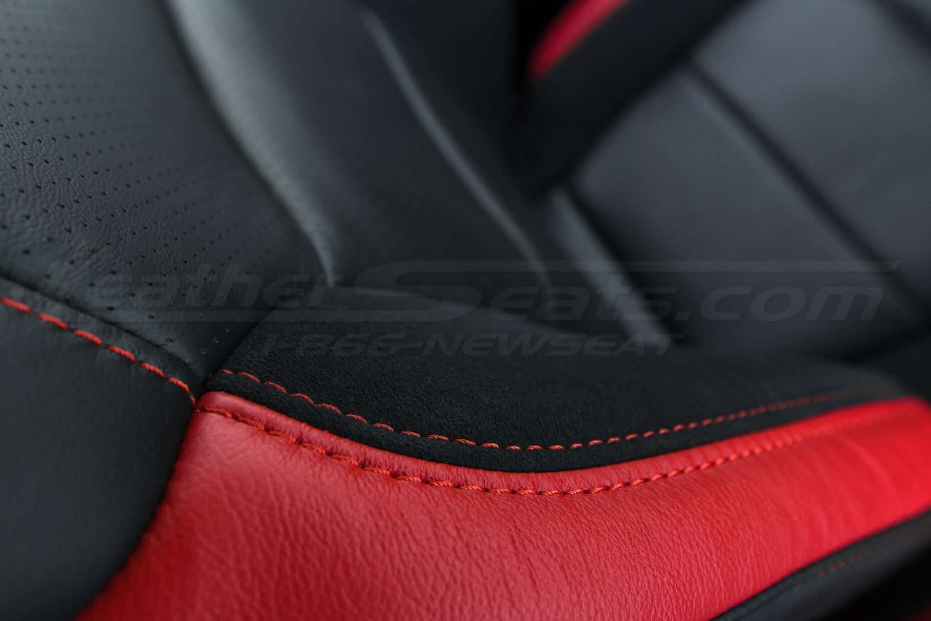 Ford Raptor installed upholstery kit - Black & Bright Red - Suede and side stitching close-up