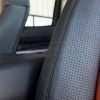 Toyota Tundra Leather Kit Installed - Black & Bright Red - Perforated wing close-up 2
