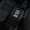 Jeep Sanctum Console charging a phone overhead view