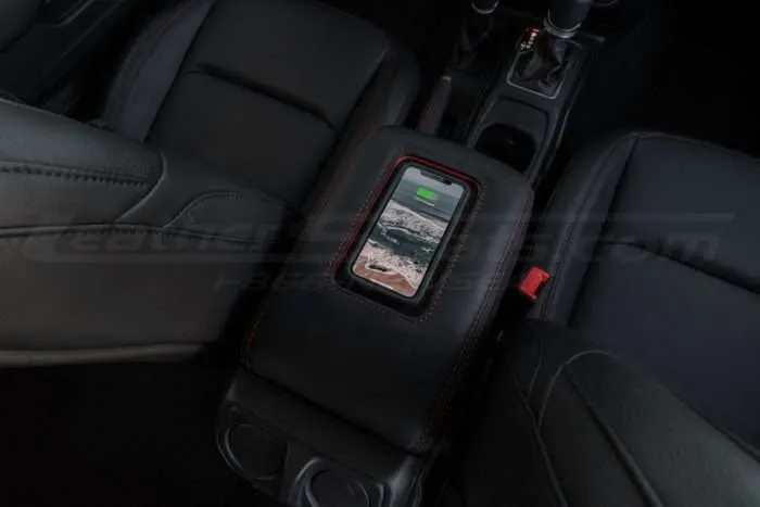 Jeep Sanctum Console charging a phone overhead view