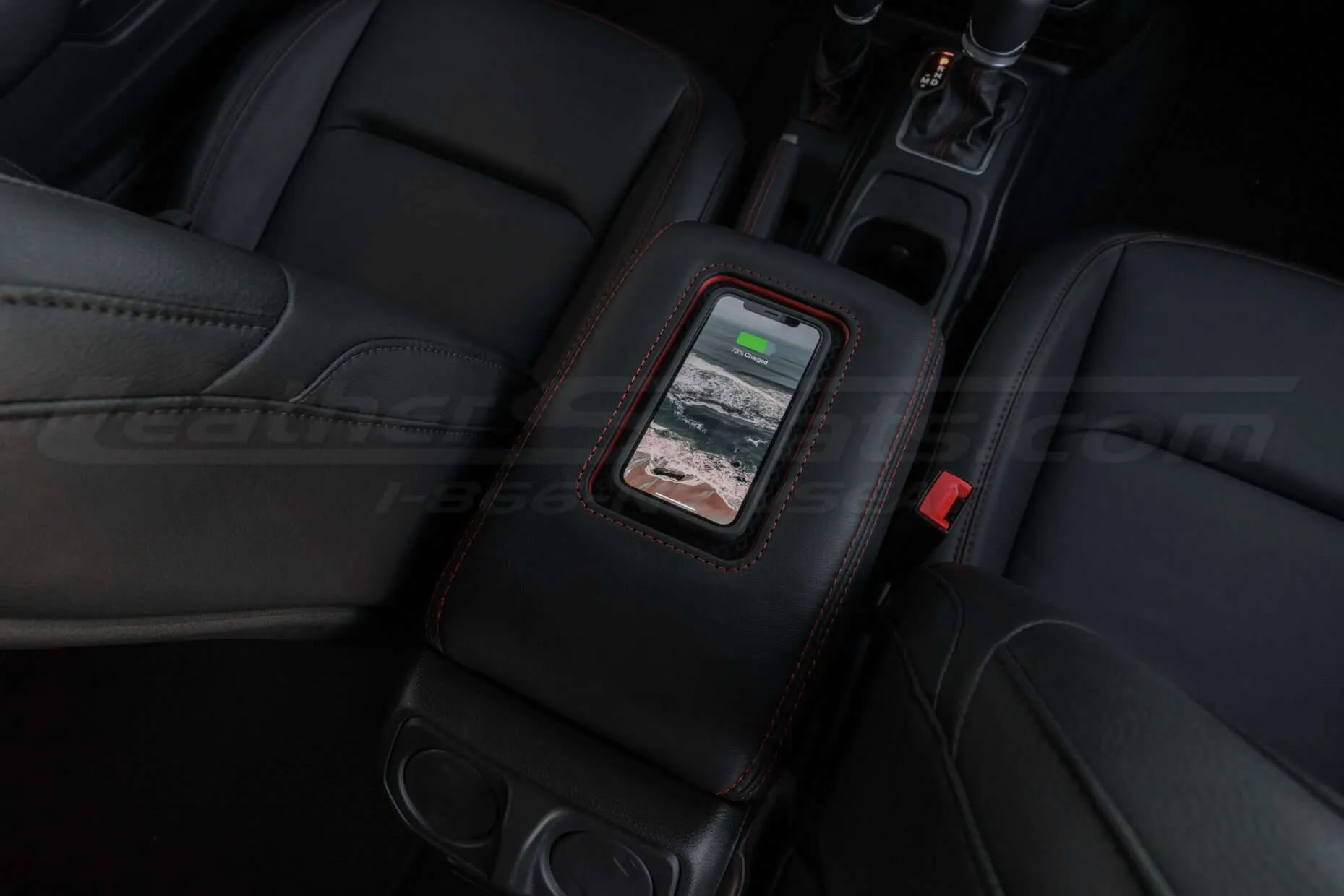 Jeep Sanctum Console charging a phone overhead view
