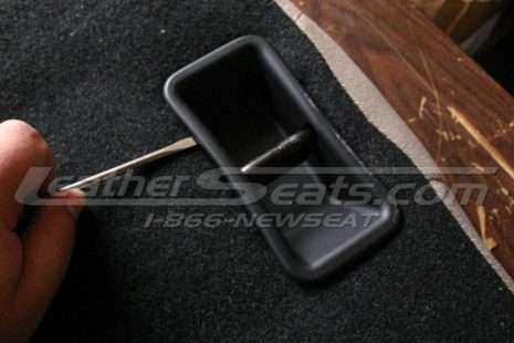 Remove the plastic trim where the seatbacks latch to the car.