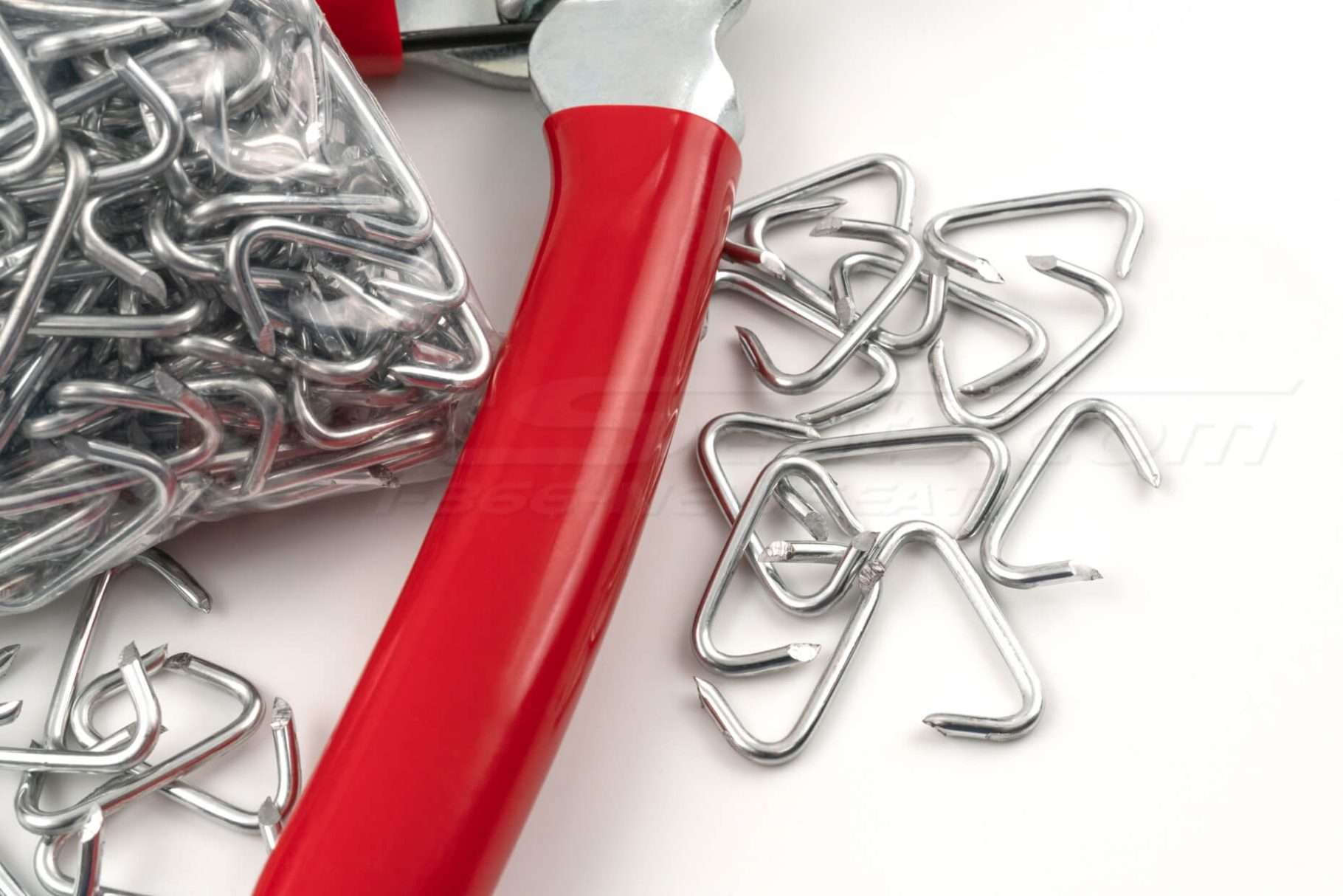 Scattered hog-rings and red hog-ring plier handle