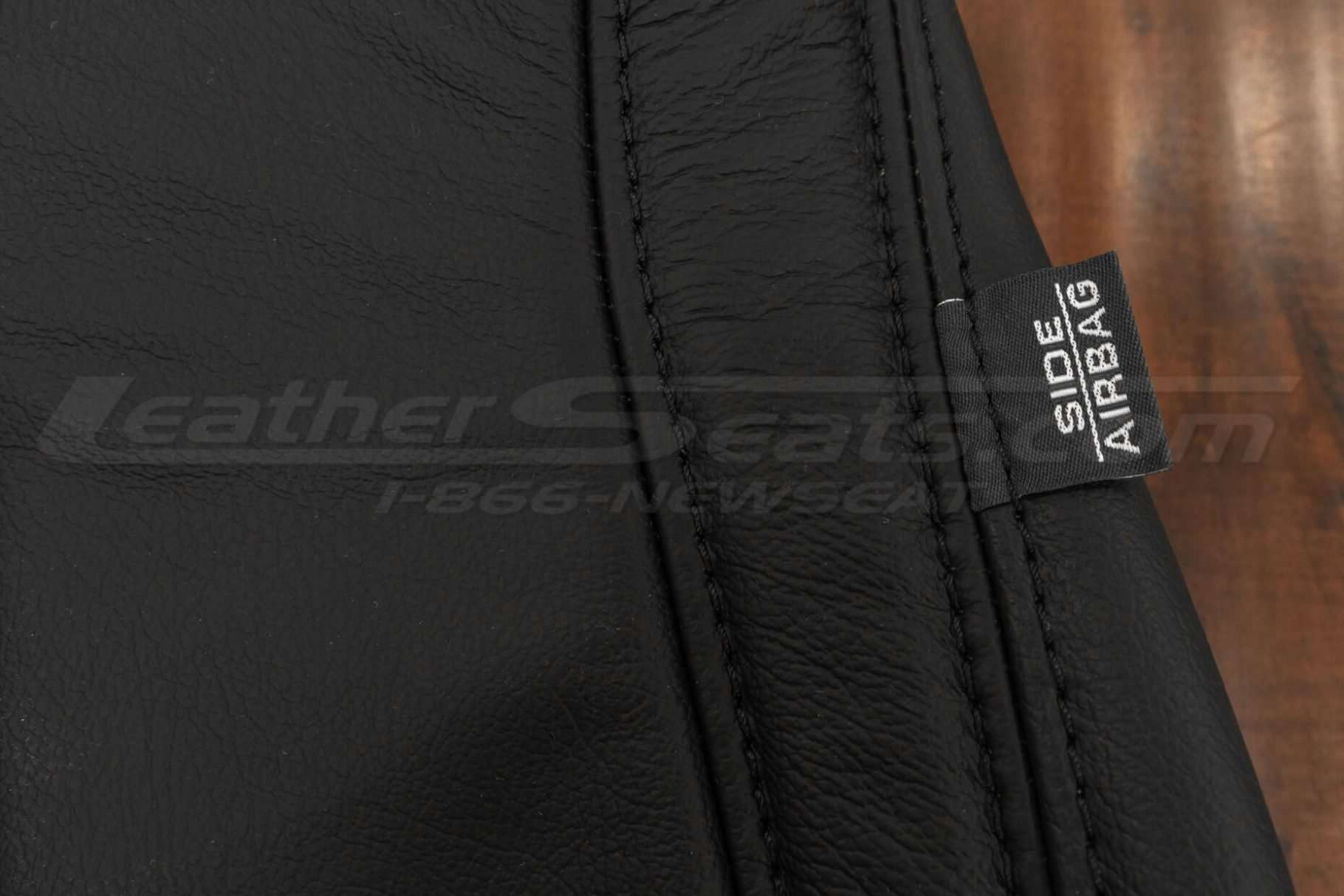 Side airbag tag with double-stitching