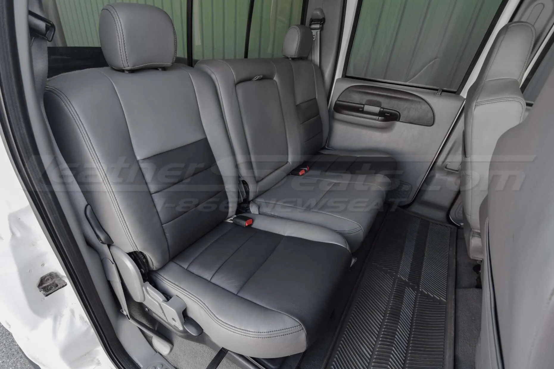 Ford Superduty installed leather seats in light grey and graphite - rear seats from passenger side