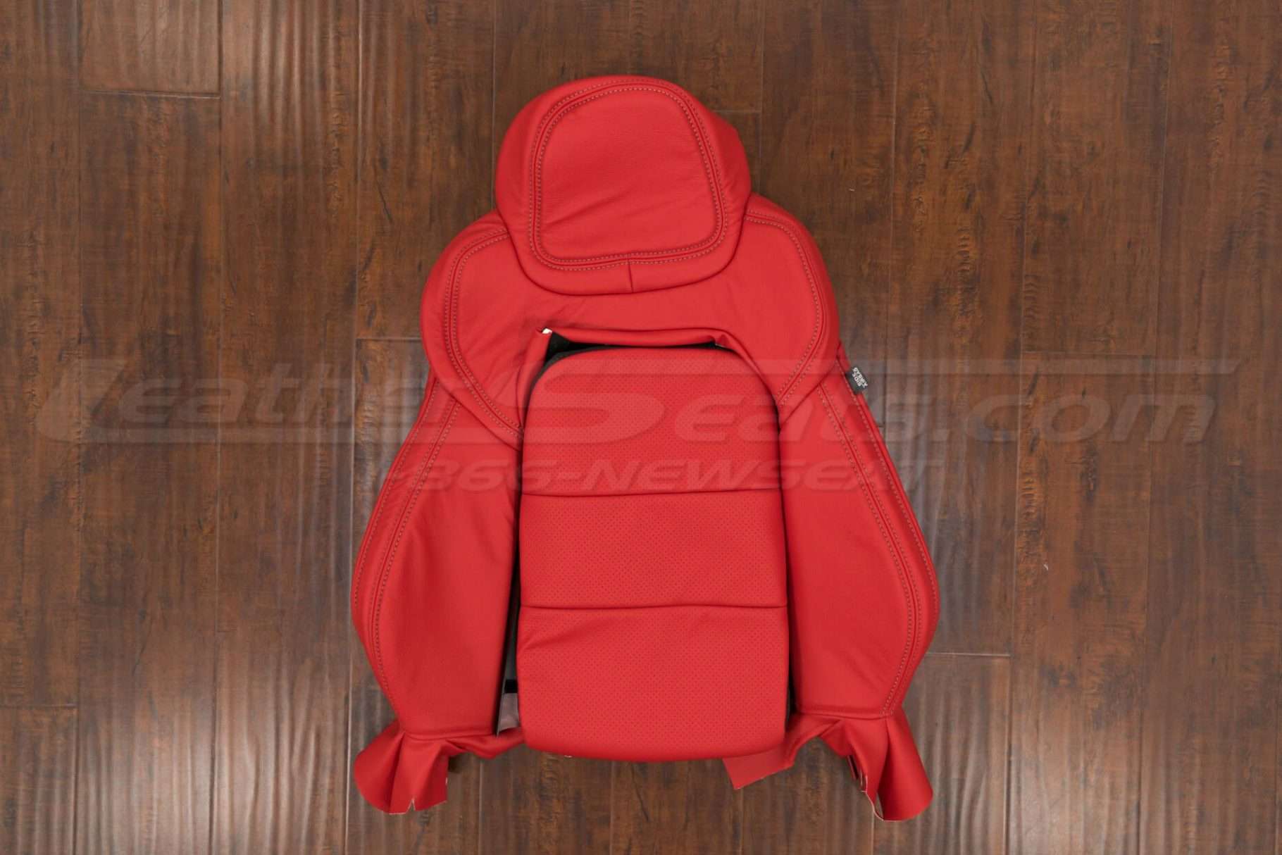 Front backrest upholstery with perforated insert