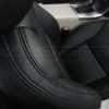 Top down view of front passenger seat with focus on stitching