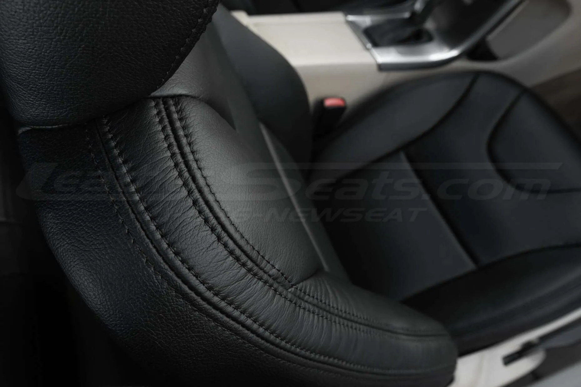 Top down view of front passenger seat with focus on stitching
