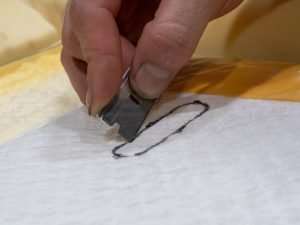 rim only the outer layer of the distribution pad, taking care not to cut through the center airflow matrix.