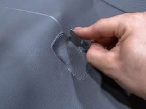 Cut a hole in the upholstery for the intake bezel