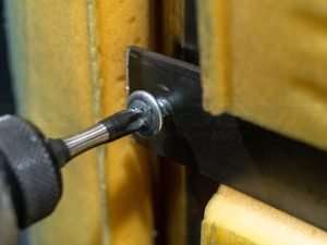 Screwing in bracket for frame placement