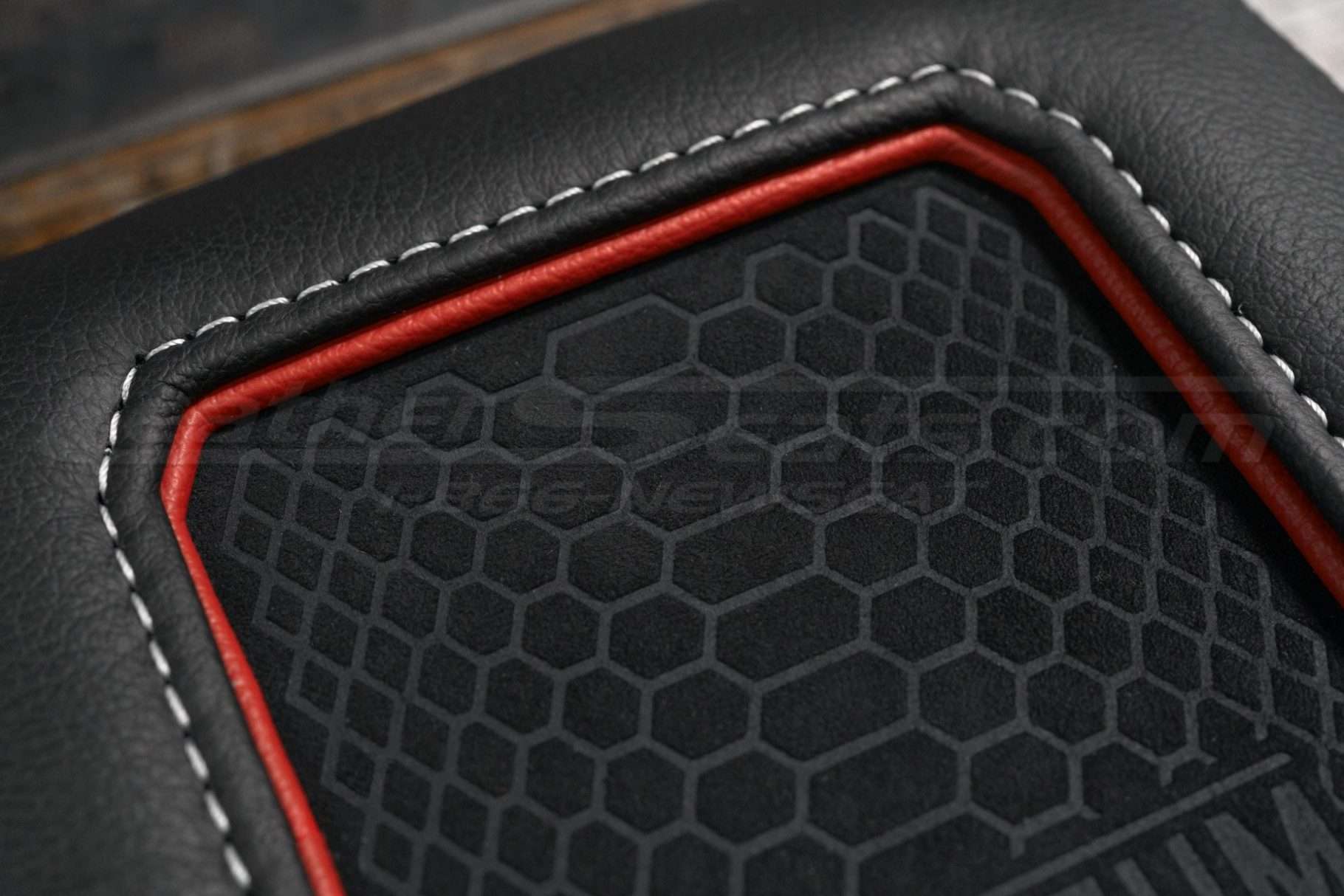 Red trim ring and whute stitching close-up