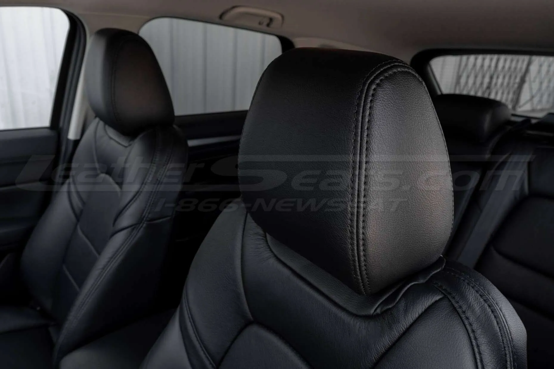 Front driver leather headrest with matching stitching