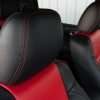 Black leather headrest with bright red contrast stitching