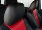 Black leather headrest with bright red contrast stitching