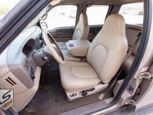 Ford Superduty with custom nutmeg leather seats - front driver side