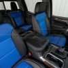 Custom leather console lid cover with installed leather seats in Black & Cobalt