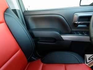 Custom leather door armrest in Black leather with contrasting silver stitching