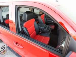 Through-window aerial view of front passenger leather seats