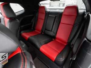 Dodge Challenger with Black and Bright Red leather seats - Rear seats from driver's side