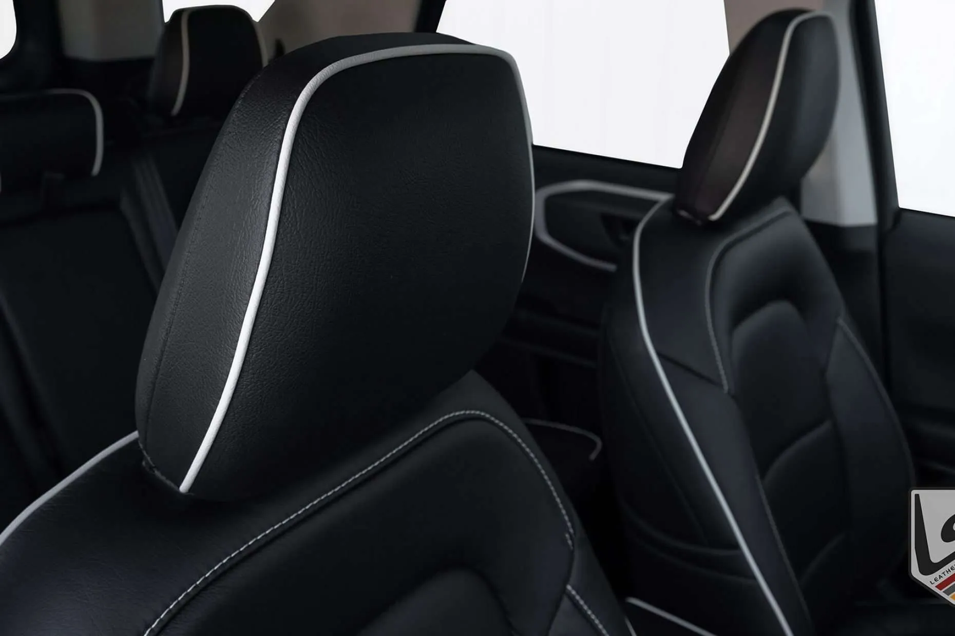 Leather headrest close-up with contrasting White Piping