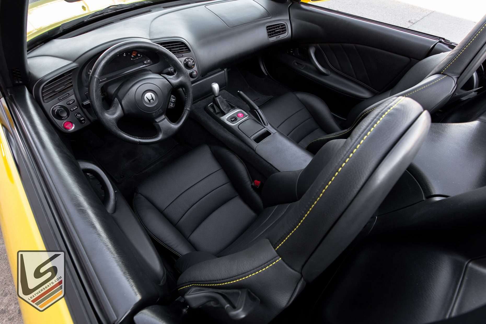 Top down view of front driver seat with focus on Sunrise top-stitching