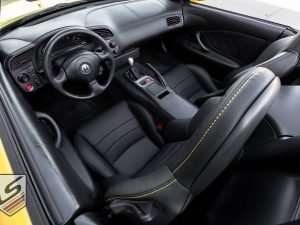 Top down view of front driver seat with focus on Sunrise top-stitching