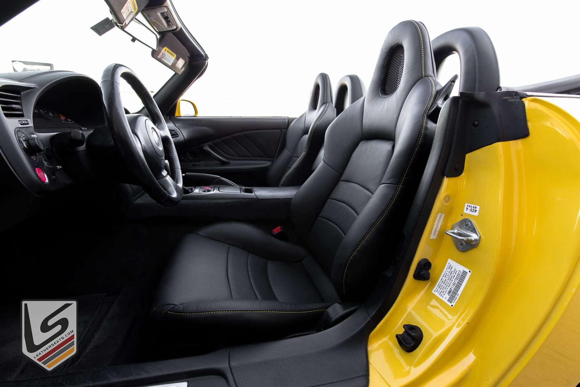 Level view of front driver leather seat in Black with perforated body