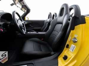 Level view of front driver leather seat in Black with perforated body