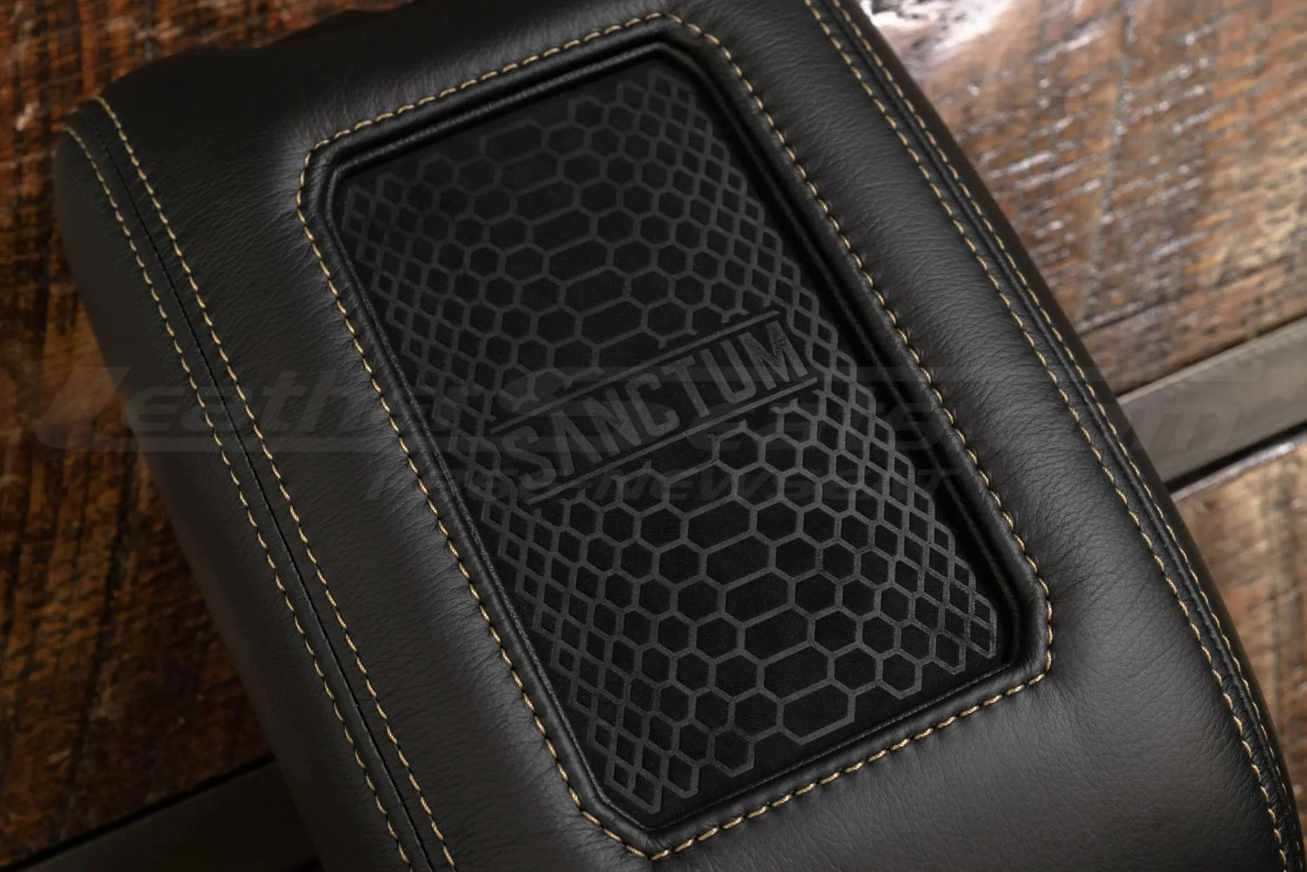 Sanctum wireless charging pad with black trim ring and tan stitching