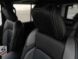 Blacm leather headrest closeup with contrasting Silver stitching