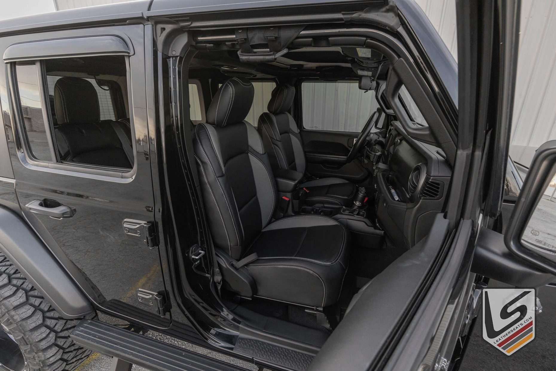 Wide angle view of front row leather interior in Jeep Wrangler JL