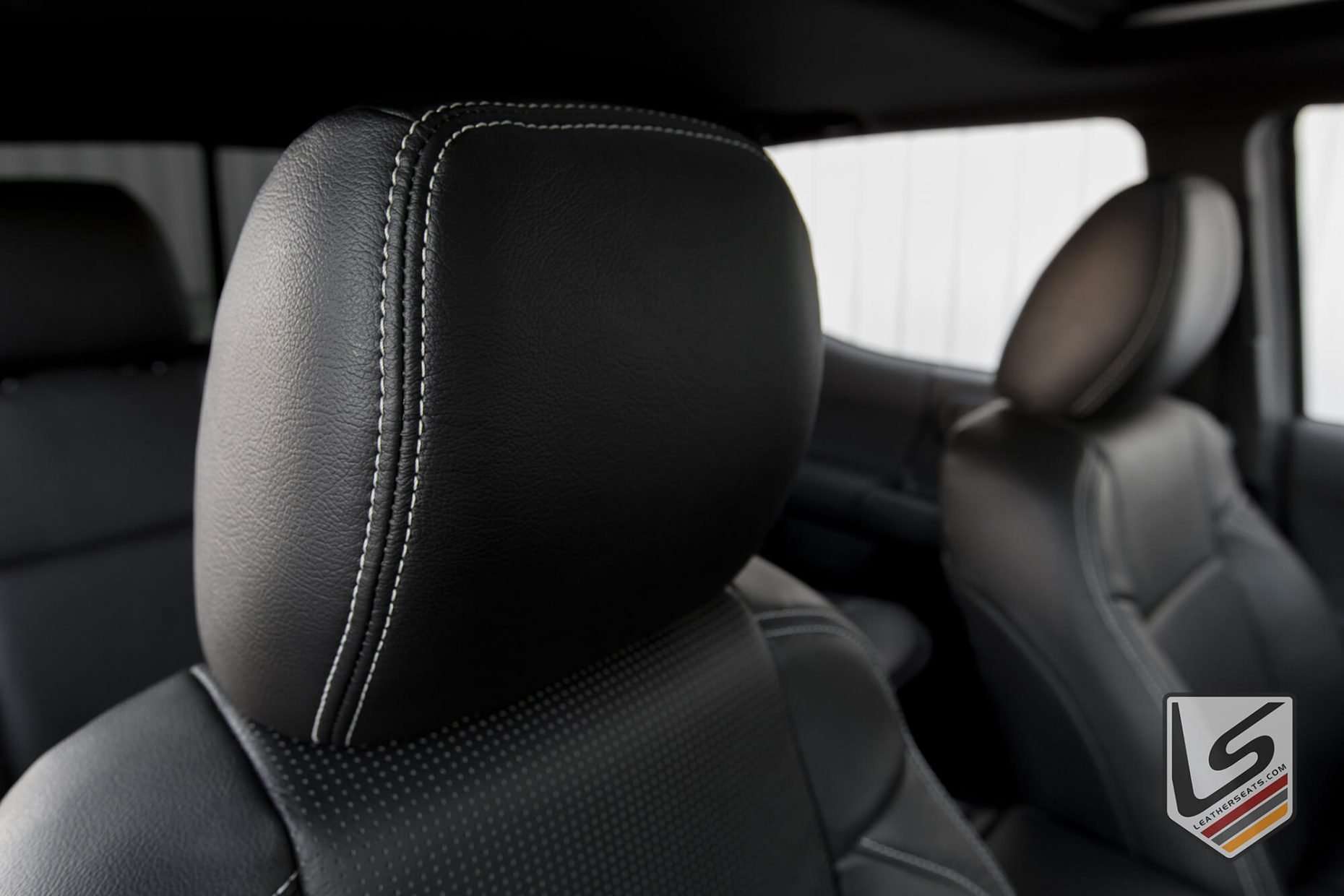 Leather headrest close-up in Black with contrasting Silver stitching