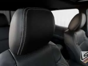 Leather headrest close-up in Black with contrasting Silver stitching