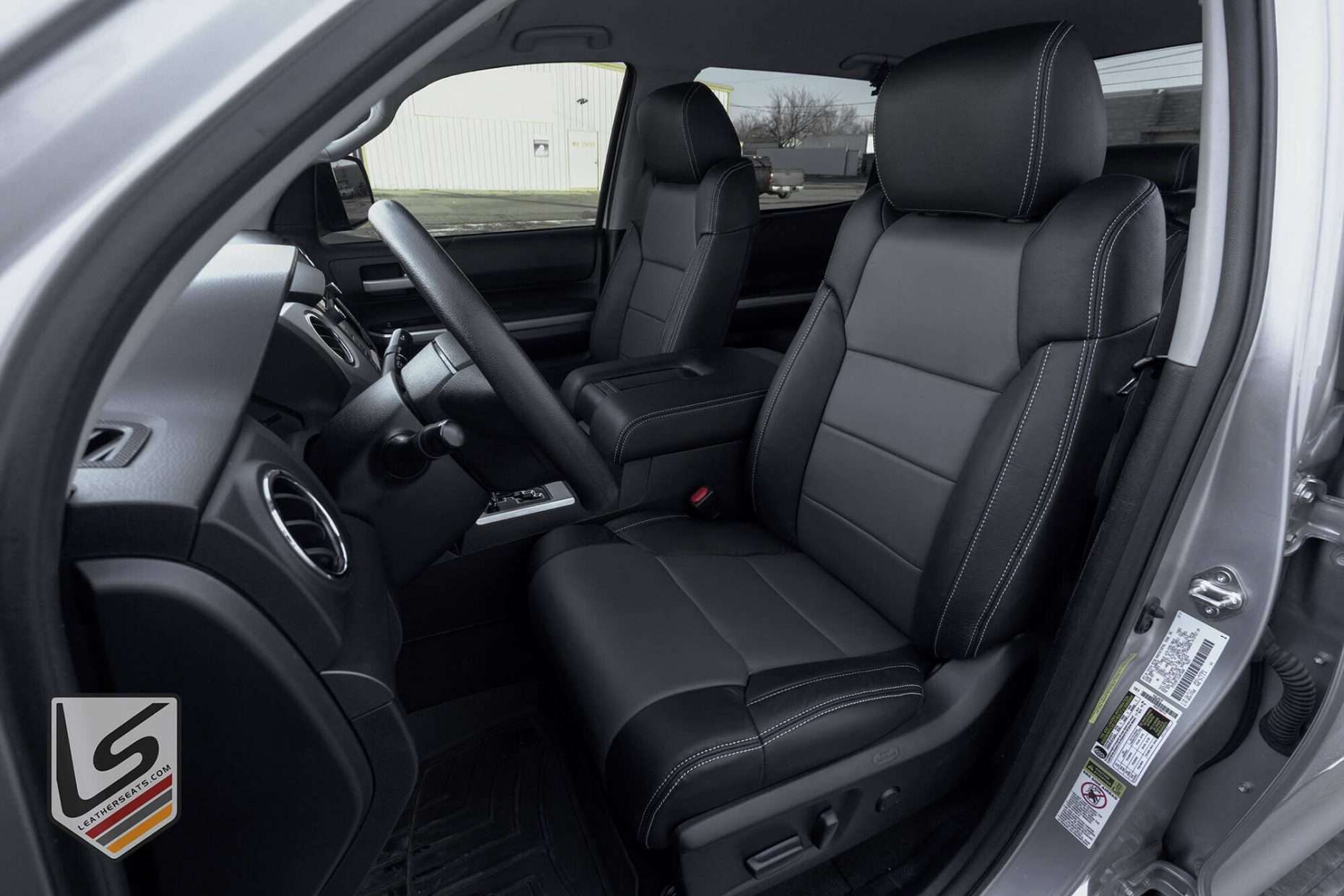 Toyota Tundra CrewMax with custom two-tone leather seats in Black with Charcoal Body - Front driver seat