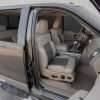 Wide view of front passenger seat with Adobe and Driftwood leather
