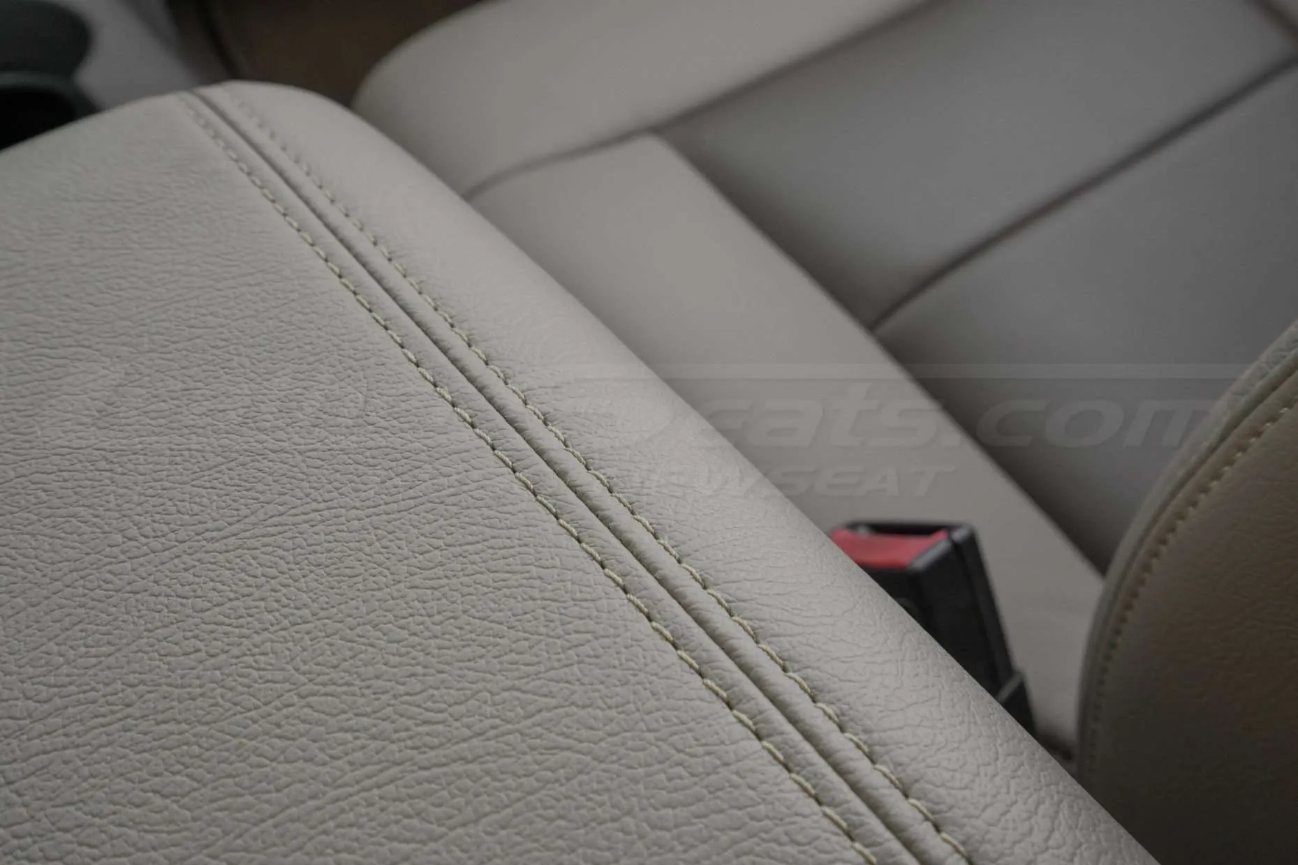 Matching double-stitching on leather console cover