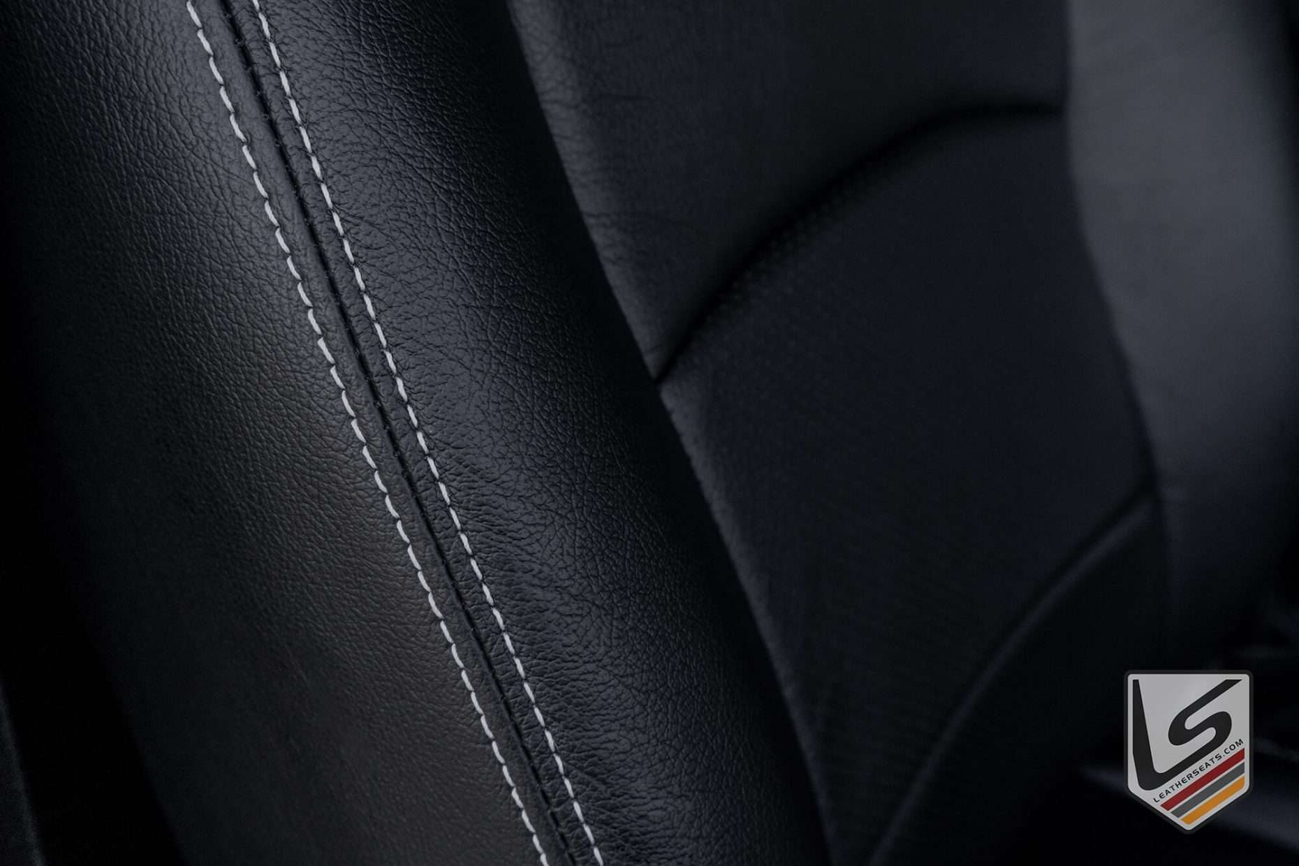 Contrasting White double-stitching on Black leather