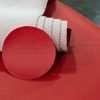Red automotive leather swatch compared to Red automotive vinyl