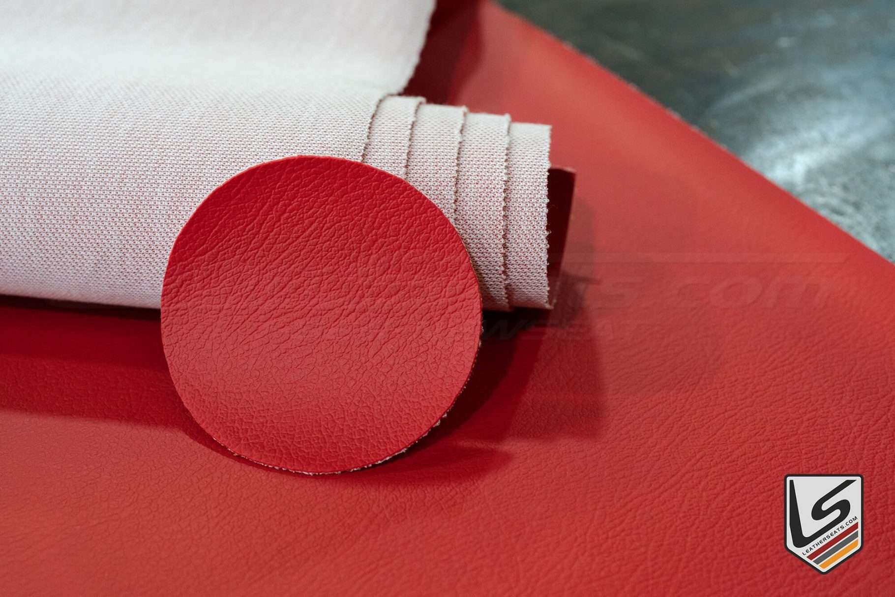 Red automotive leather swatch compared to Red automotive vinyl
