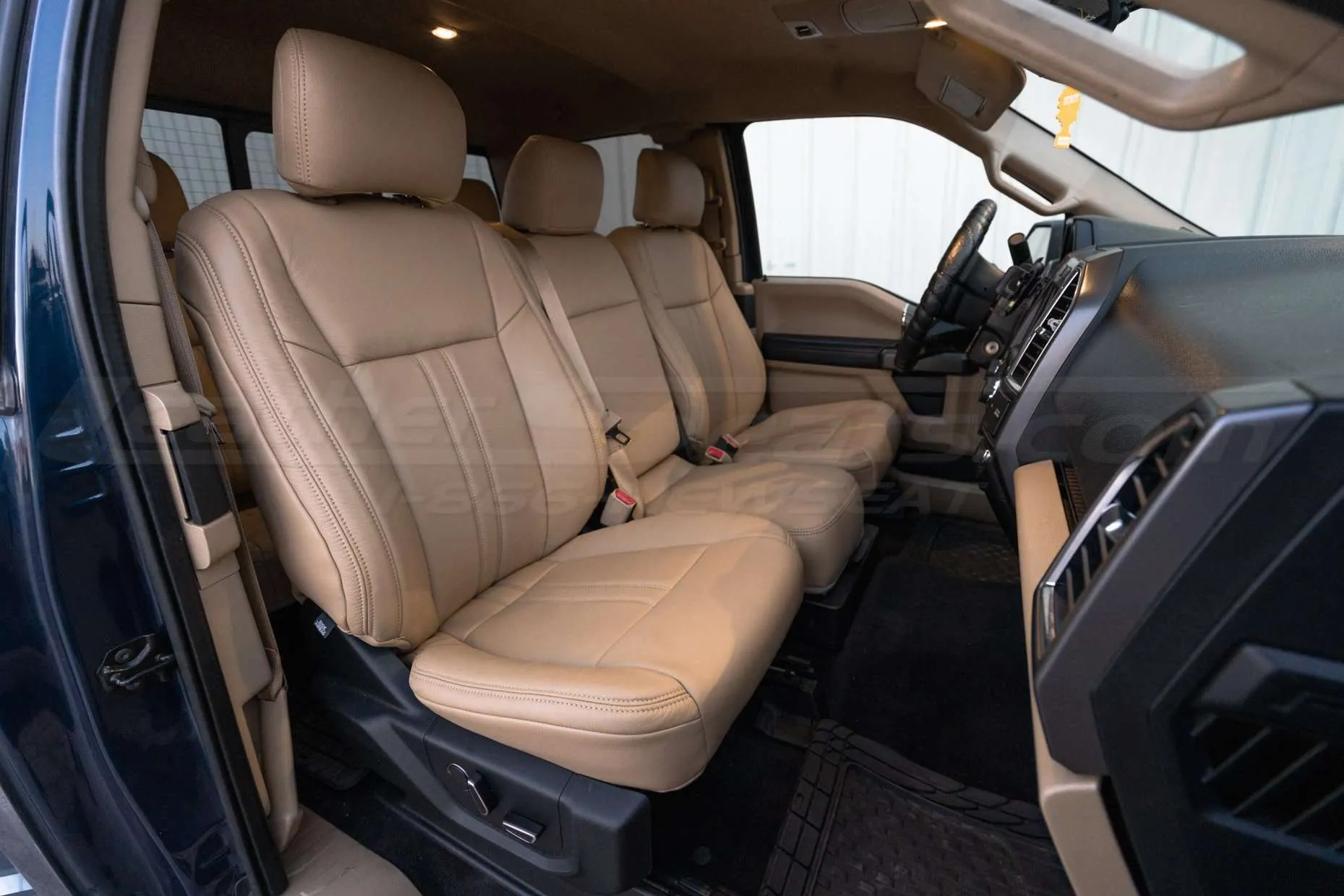 Front passenger view of Bisque leather seats with raised jump seat