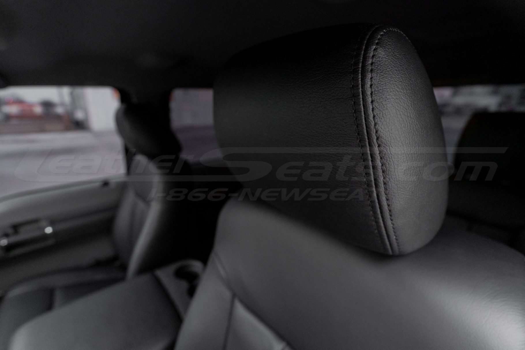 Leather headrest close-up with matching stitching
