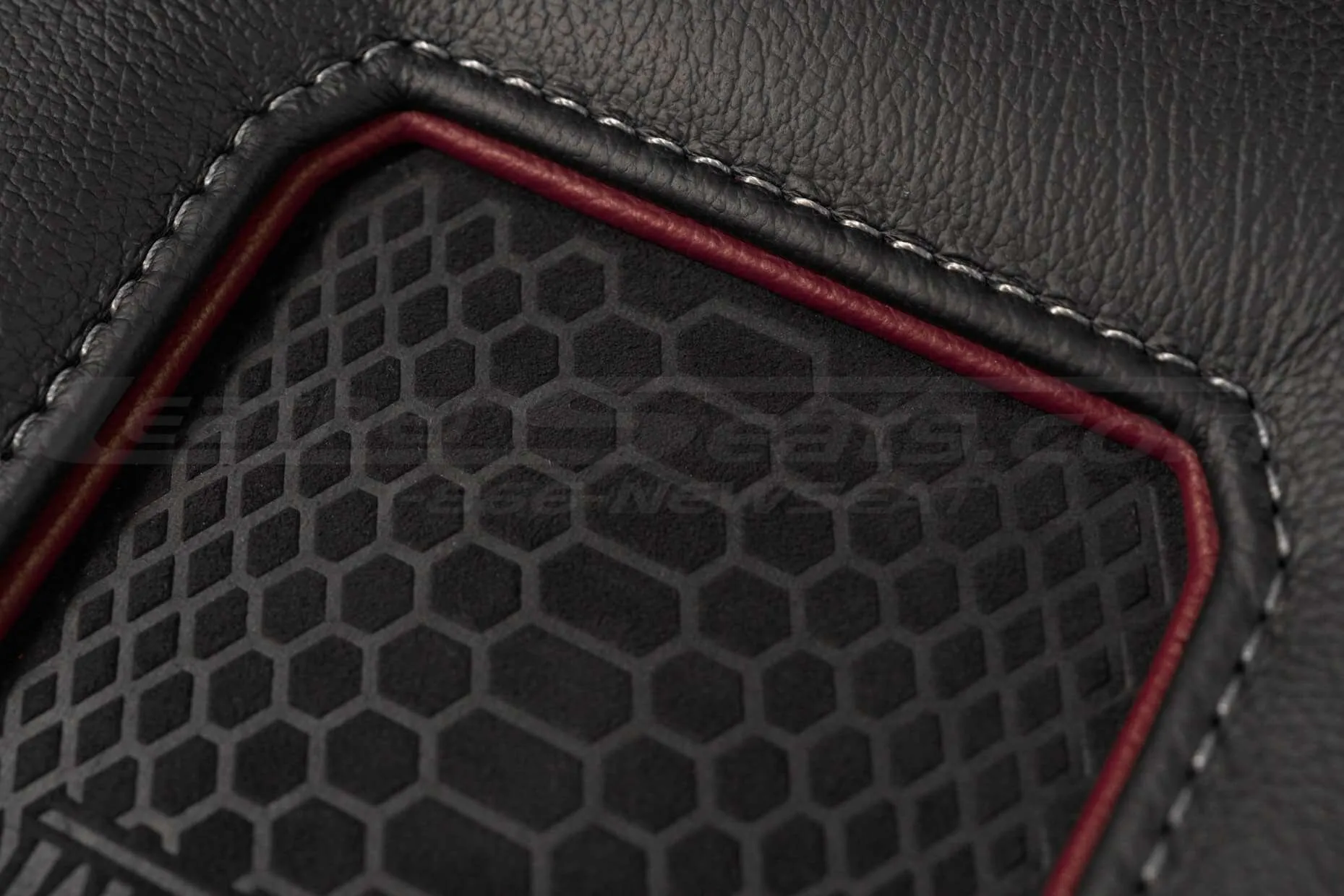 Black leather with Grey stitching and Medium Red trim ring close-up