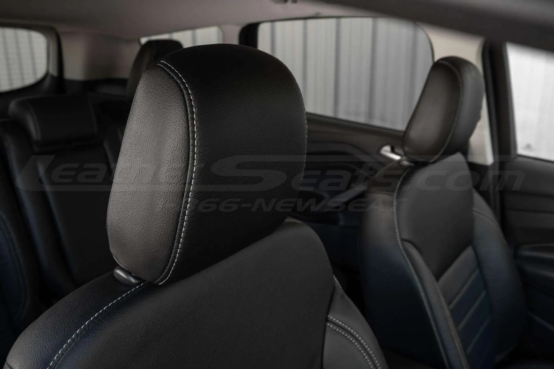 Installed leather headrest close-up with contrasting Frost stitching