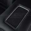 Phone charging pad close-up on leather center console lid