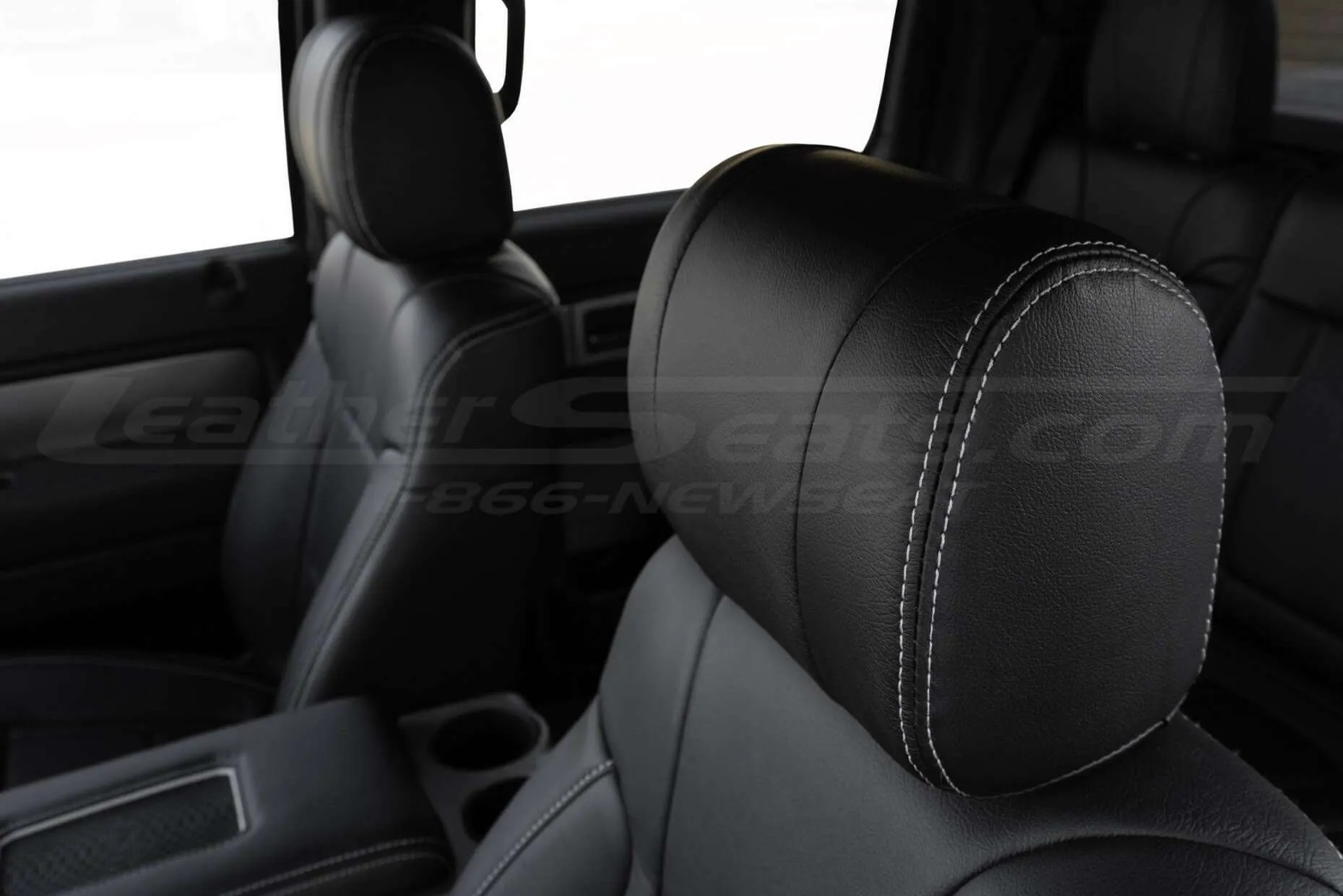Front leather headrest with silver stitching close-up