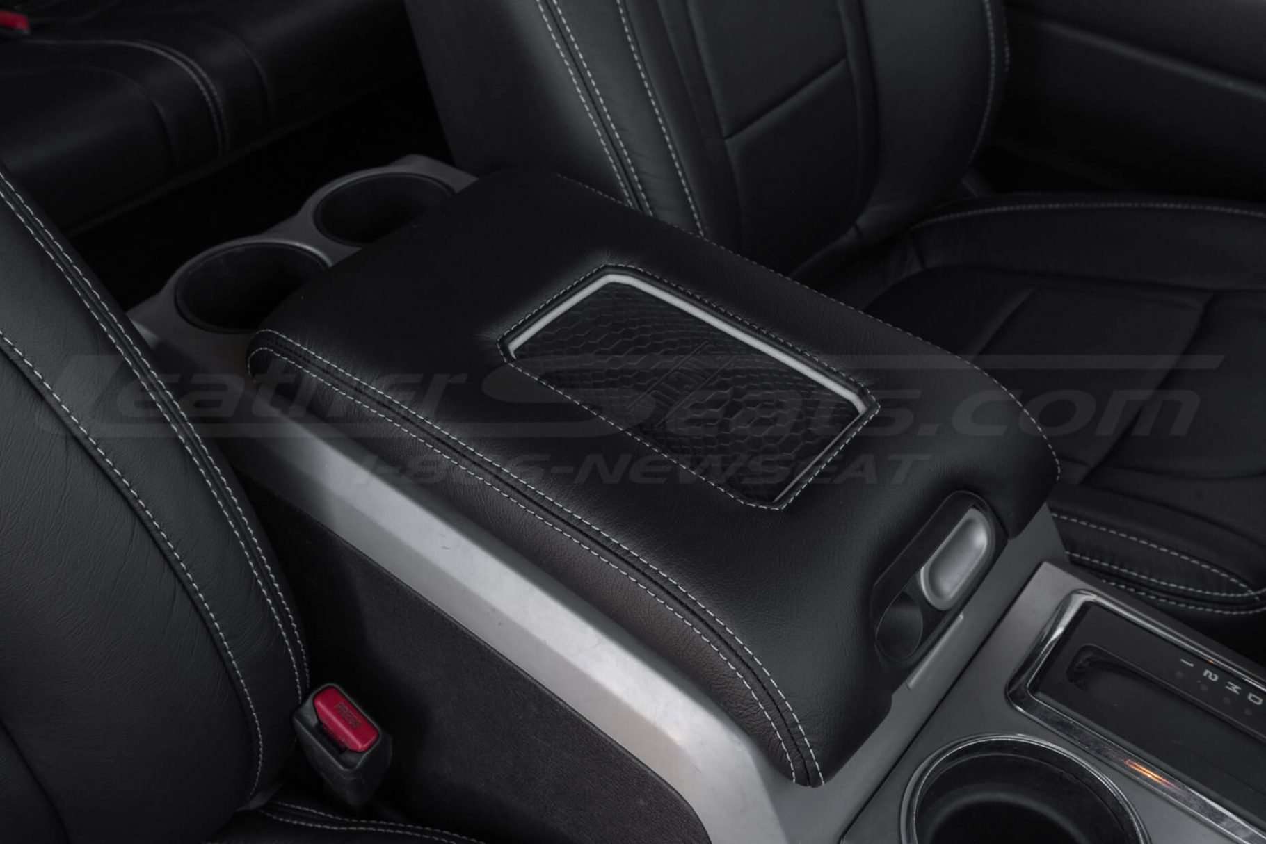 Black leather with silver trim ring and stitching phone charging console