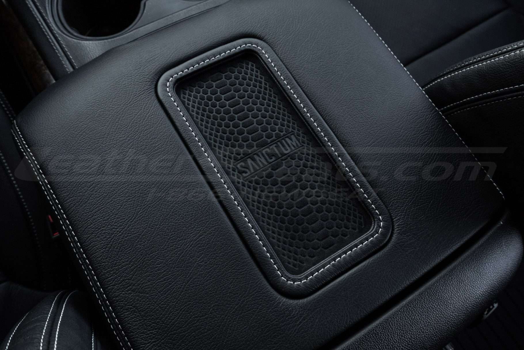 Drop in wireless phone charging pad close-up with silver stitching